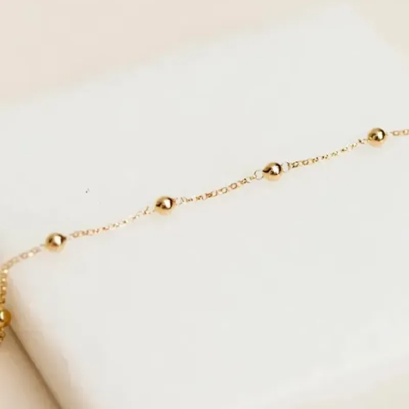 PULSEIRA DUPLA ELOS CORAÇÃO + BOLINHAS 18K